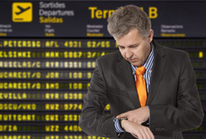 A man checking his watch waiting on transportation for corporate travel