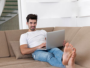 Gentleman on Laptop in Furnished Apartment